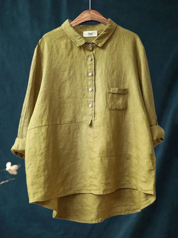Woman wearing a plain flowing summer blouse in a warm solid colour, falling softly around her figure.
