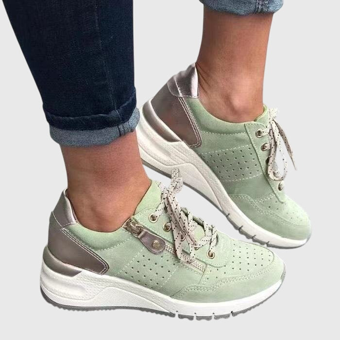 A woman on a walk wearing soft, supportive sneakers on a bright day.