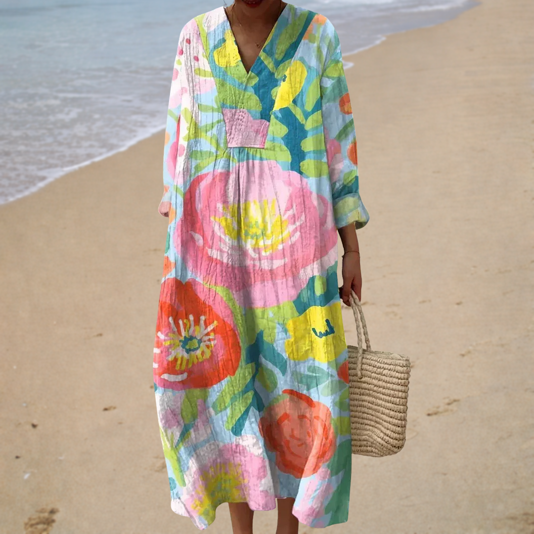 A woman wearing a flowing printed summer dress that drifts gently as she walks in the sunshine.