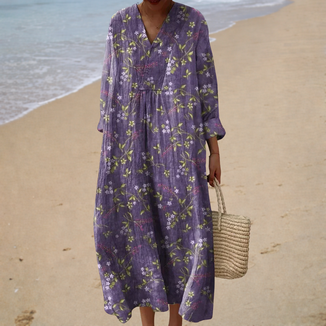 A woman wearing a soft printed summer dress with a gentle, flowing drape at a summer gathering.