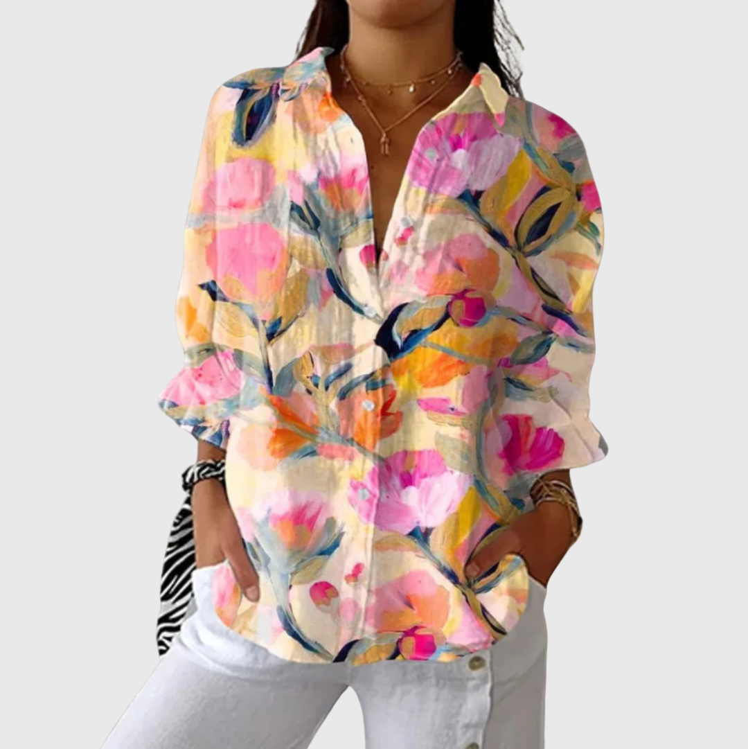 A woman wearing a relaxed colourful printed blouse with an elegant button front, comfortable and bright on a day out.