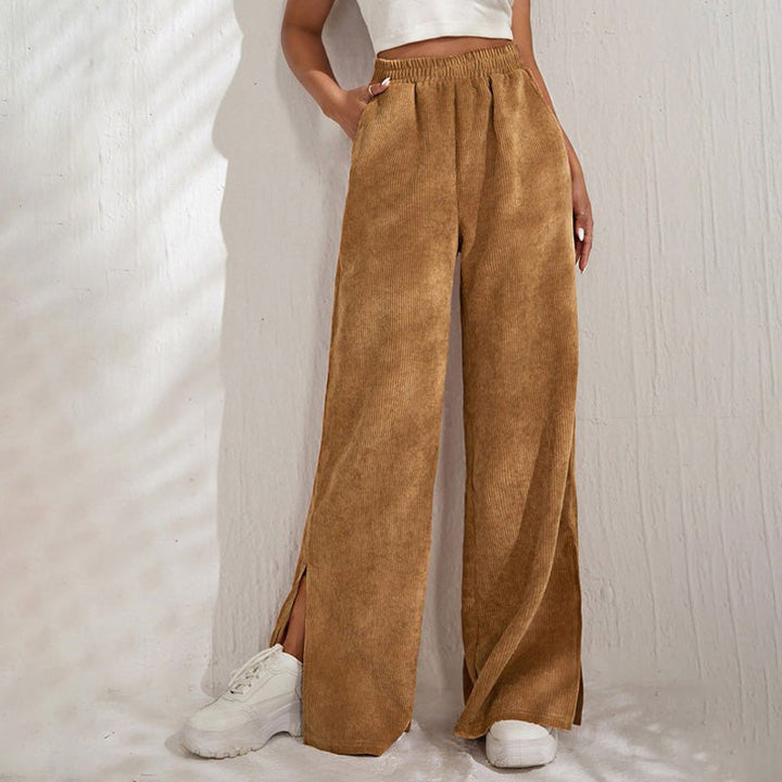 Woman wearing wide-leg ribbed joggers with a fitted top, relaxed at home.