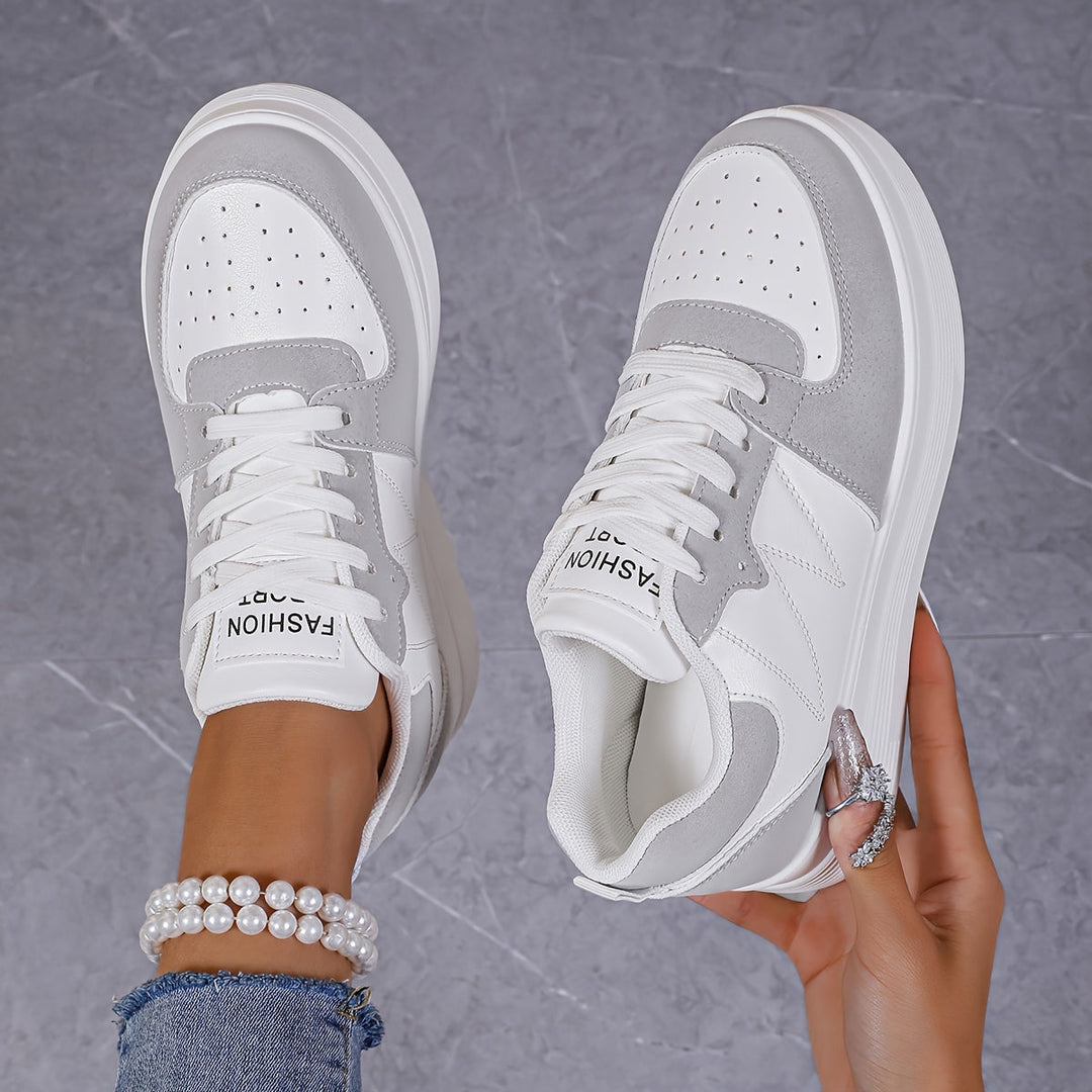 A woman wearing elegant two-tone platform sneakers in the city