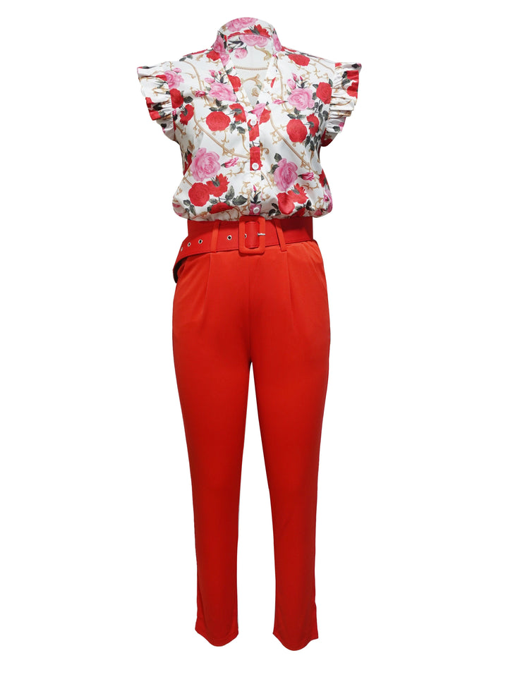A woman wearing a floral ruffle-sleeve top with high-waisted pants, elegant and striking.