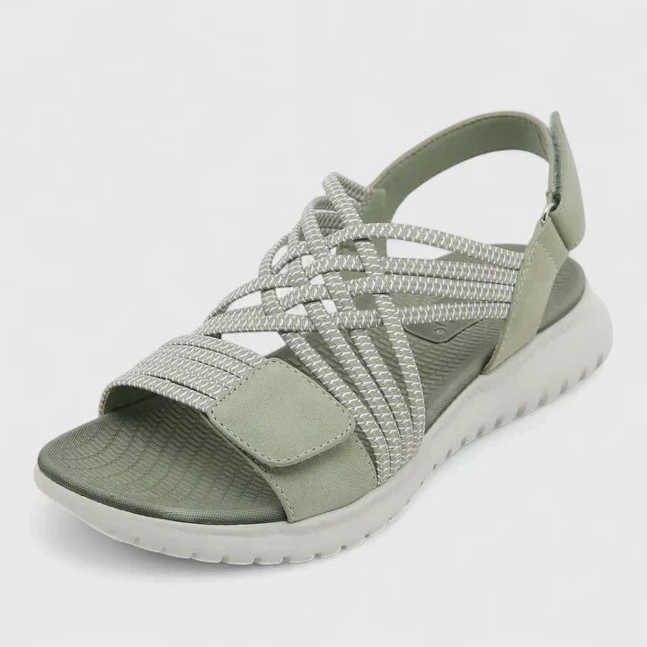 A woman walking freely in lightweight wide-fit orthopaedic sandals with an open front.