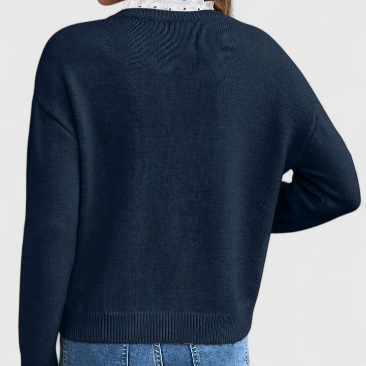 A woman wearing an elegant top with delicate detailing, flattering and comfortable for day to evening.