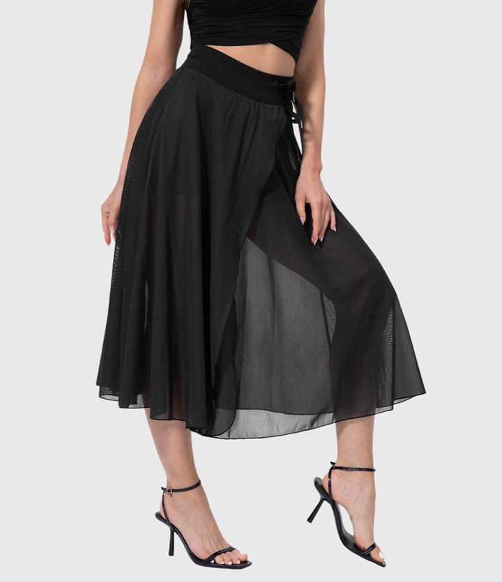 A woman in an elegant high-waisted flowing skirt, styled for a versatile day-to-evening look.