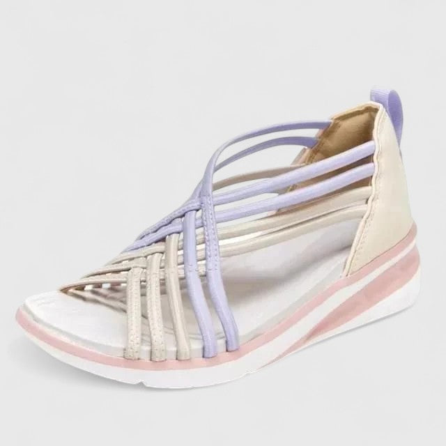 A woman walking comfortably in wide-fit multi-strap orthopaedic sandals with an open design.