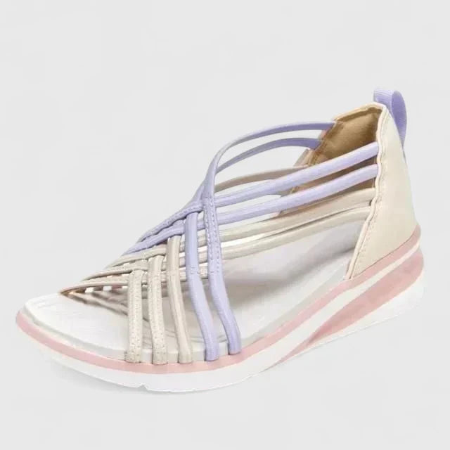 A woman walking with ease in elegant wide-fit everyday sandals with a cushioned footbed.