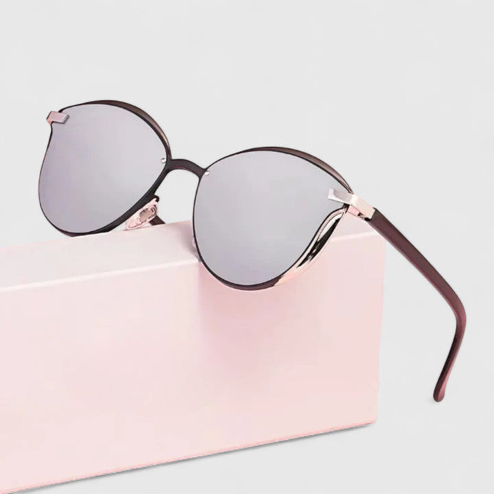 A woman wearing minimalist polarised gradient sunglasses on a bright day.