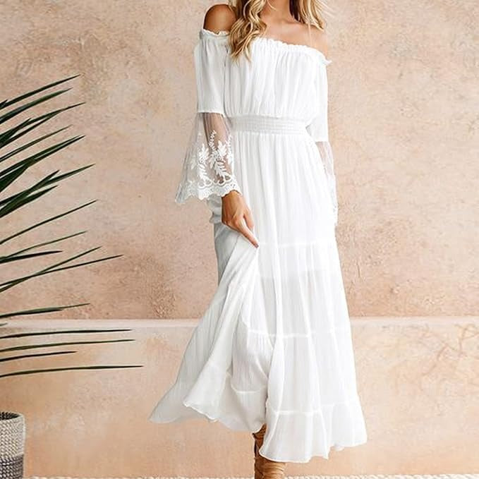 Woman wearing a romantic off-shoulder maxi dress with sheer embroidered sleeves at an evening celebration.