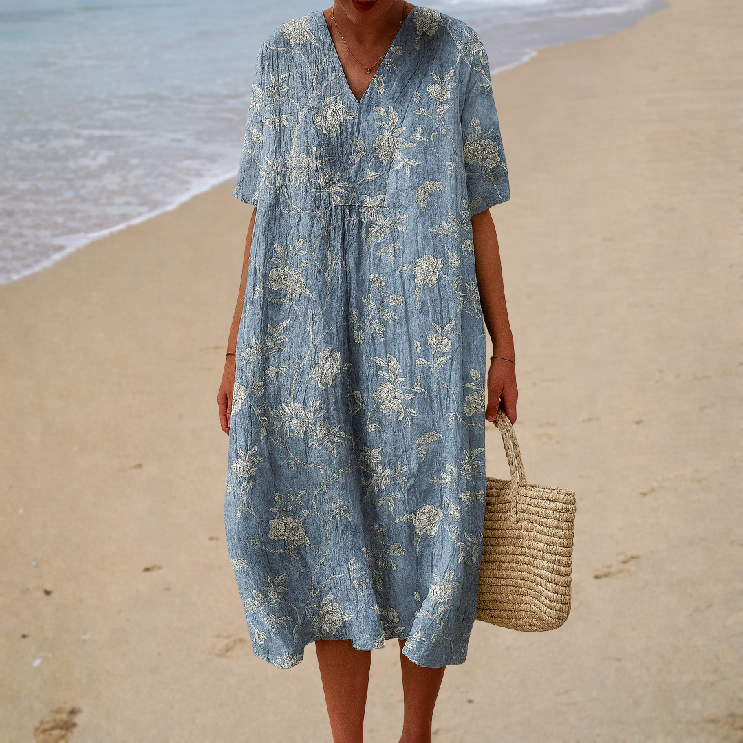 A woman in a printed summer dress with a light, swaying skirt, enjoying a sunny day.