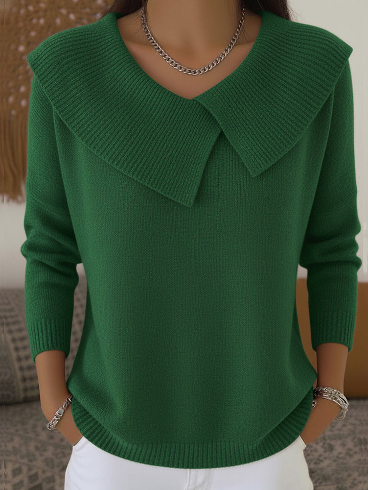 A woman wearing a soft collared sweater styled elegantly for a festive occasion.