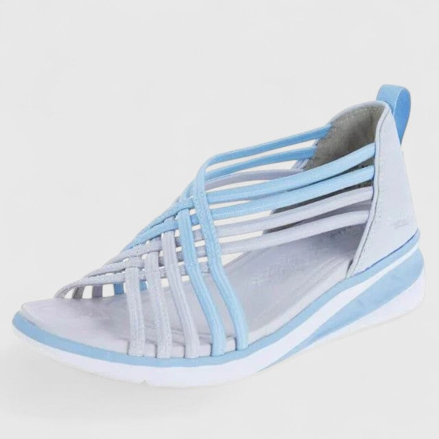 A woman walking comfortably in wide-fit multi-strap orthopaedic sandals with an open design.