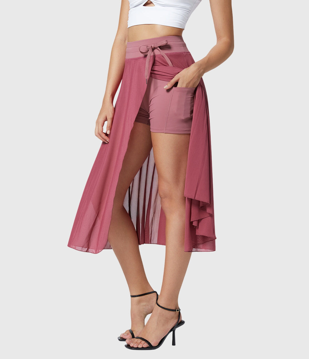 A woman in an elegant high-waisted flowing skirt, styled for a versatile day-to-evening look.