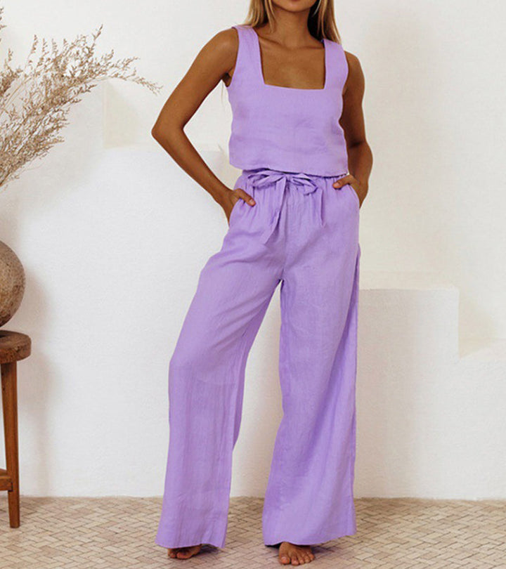 A woman wearing a minimal two-piece set with a square neckline and belted flared pants.