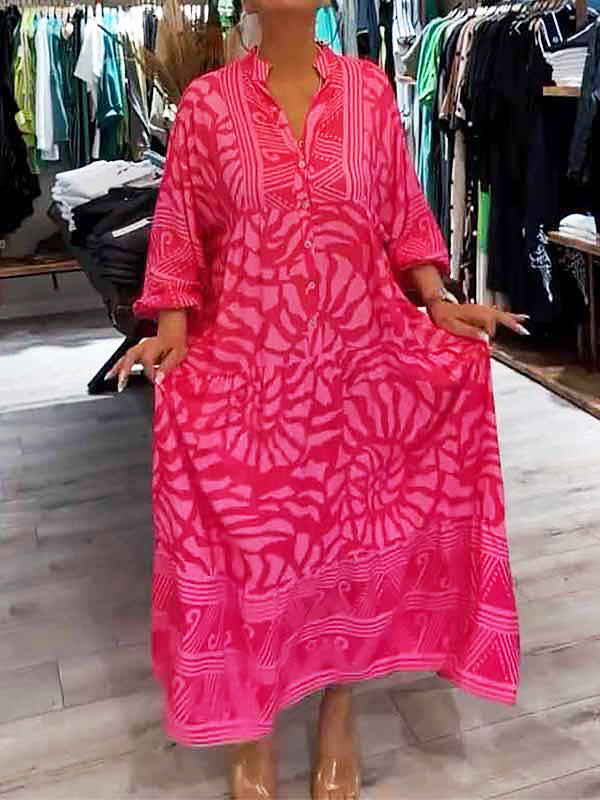 Woman wearing the Gina™ vivid printed maxi dress with a button front, standing confidently outdoors.