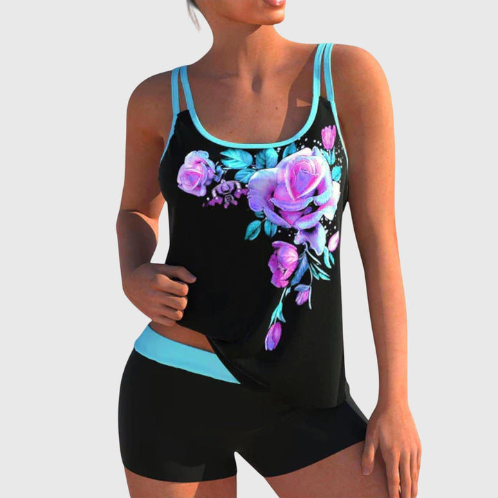 A woman by the water in a fresh printed two-piece swimsuit, relaxed and confident in the sun.
