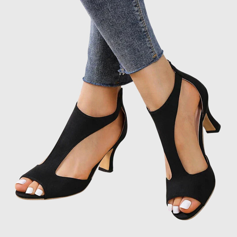 A woman in soft pink supportive heels walking with ease through her day.