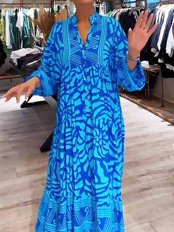 Woman wearing the Gina™ vivid printed maxi dress with a button front, standing confidently outdoors.