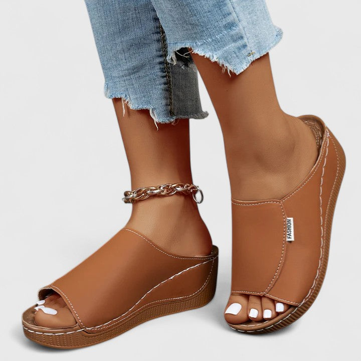 A woman in tan lightweight sandals stepping out gracefully, feet cushioned and supported.