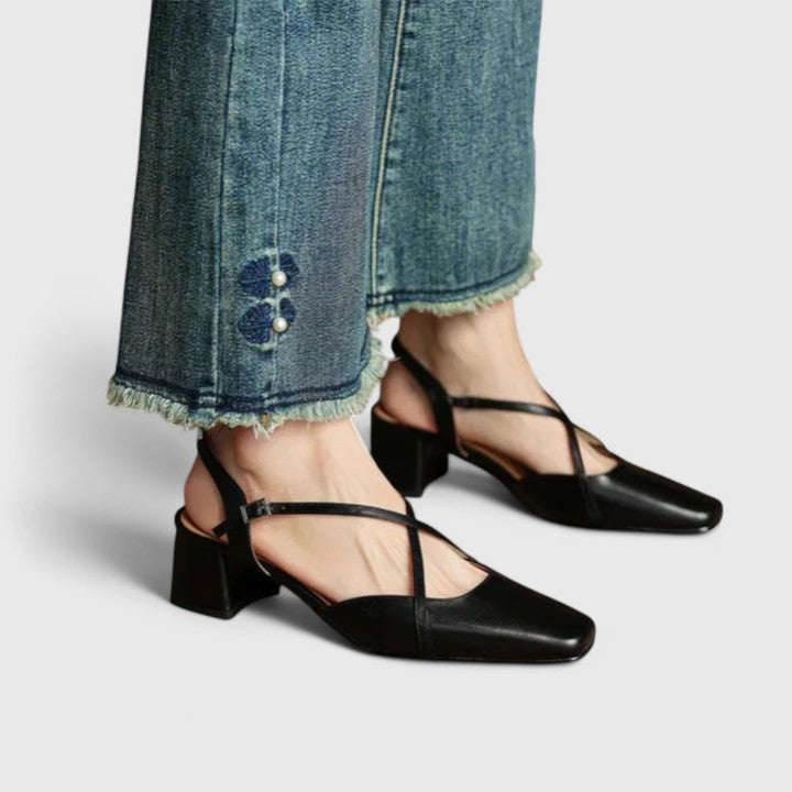Burgundy closed square-toe flats with criss-cross instep straps and a buckled slingback.