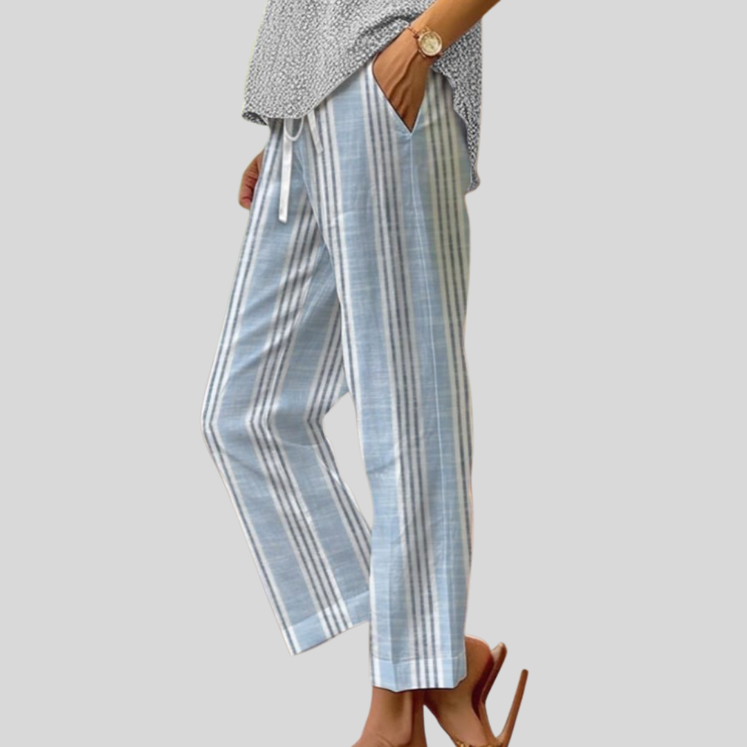 Woman wearing light blue and white vertically striped pants with a soft top.