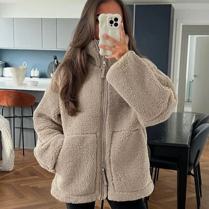 A soft, textured winter jacket with a tall stand collar, zip front and patch pockets