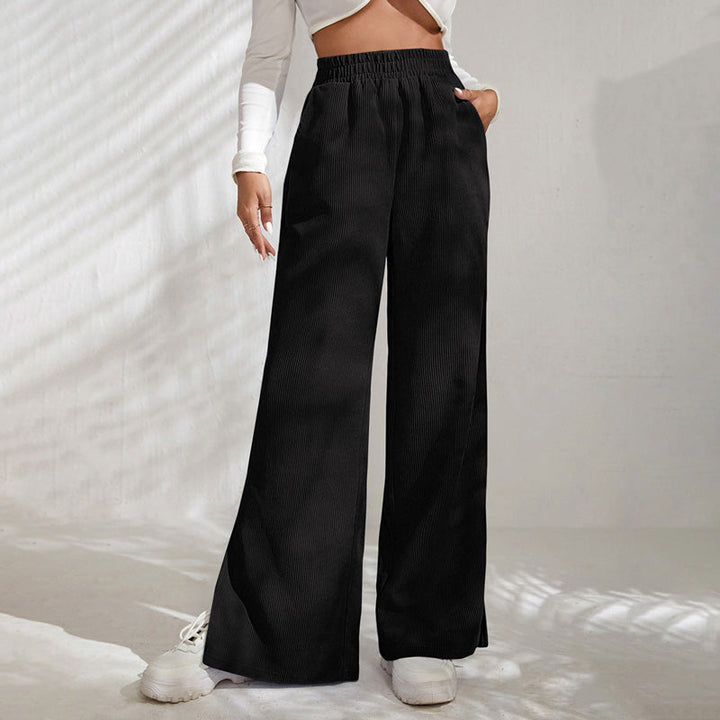 Woman wearing wide-leg ribbed joggers with a fitted top, relaxed at home.