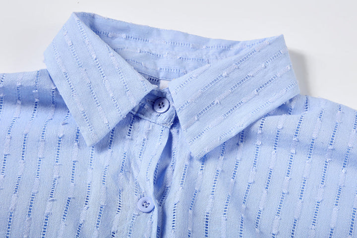 A woman wearing a classic button shirt with matching relaxed shorts, polished and easy.