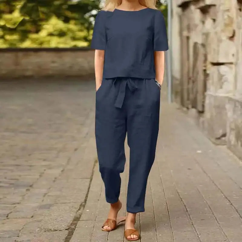 A woman wearing a relaxed short-sleeve top and matching drawstring pants lounge set.