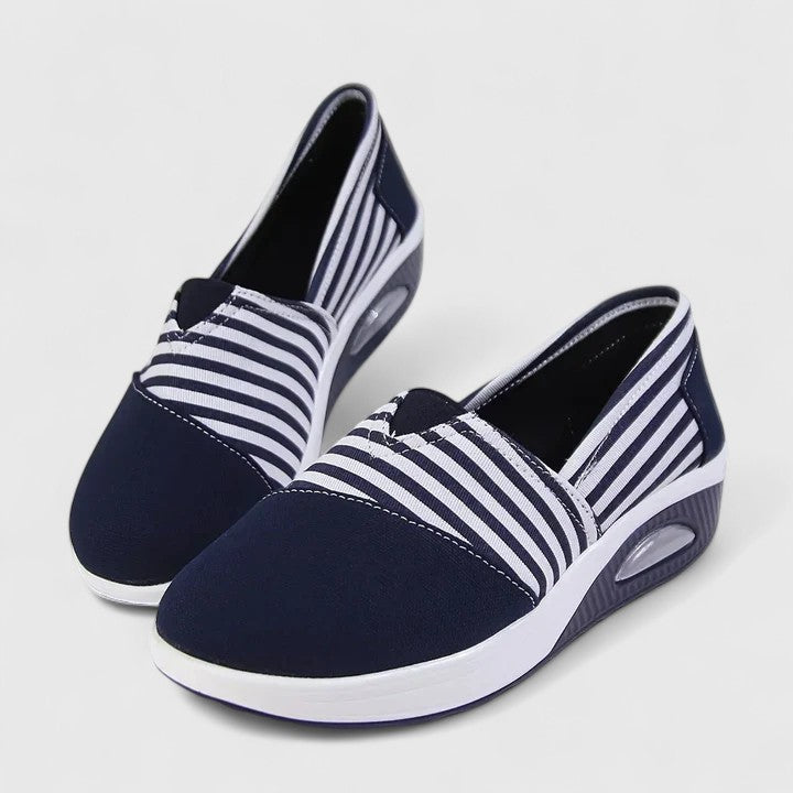 A woman wearing blue striped orthopaedic sneakers on a walk