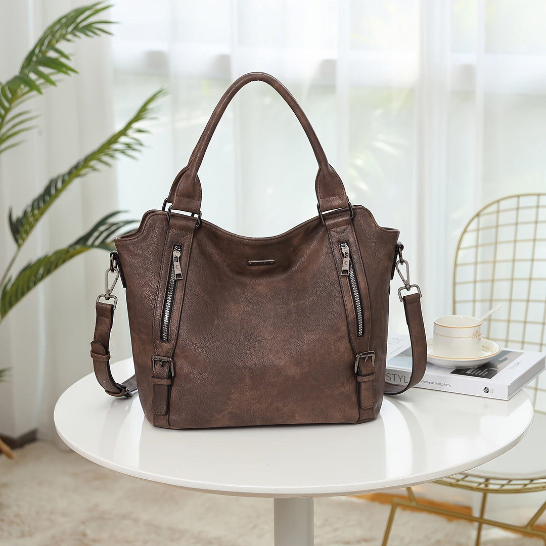 A woman wearing a roomy shoulder bag across her body while out running errands.
