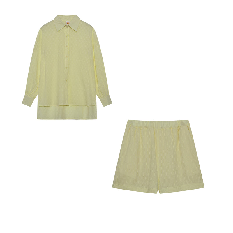 A woman wearing a classic button shirt with matching relaxed shorts, polished and easy.