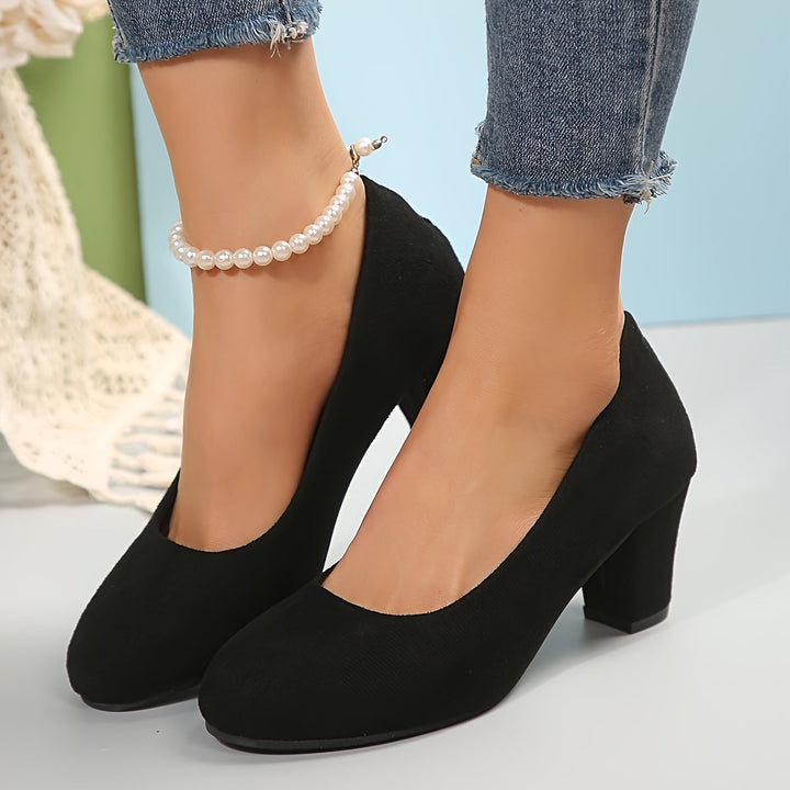 A woman in sturdy block heels standing comfortably and confidently through a long day.
