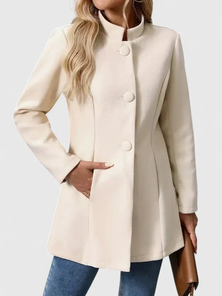 A woman wearing a tailored jacket with a neat stand collar and a button front