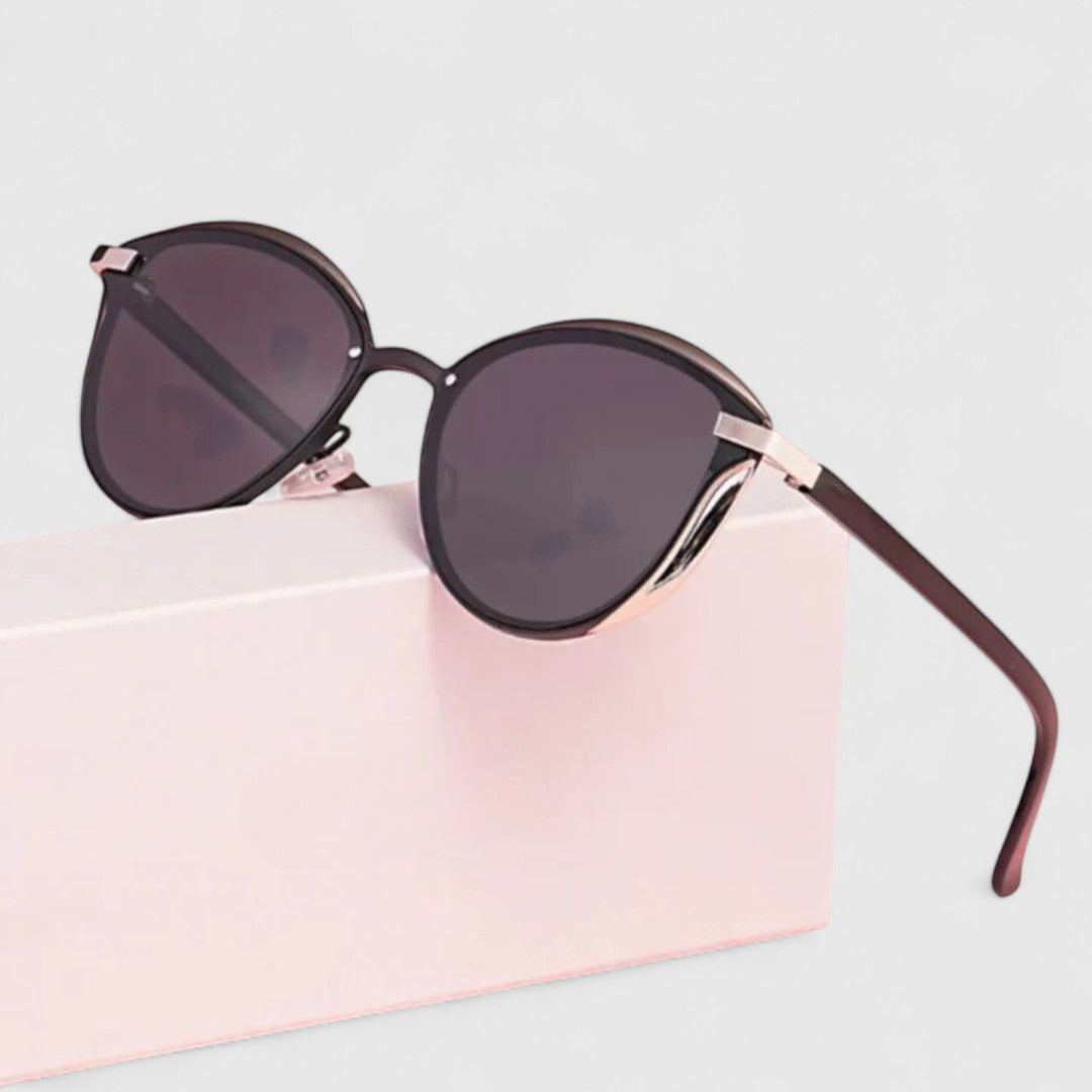 A woman wearing minimalist polarised gradient sunglasses on a bright day.
