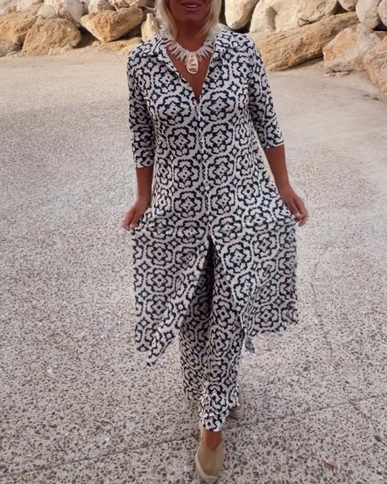 A woman wearing a black-and-white geometric-print longline top with matching pants, standing outdoors.