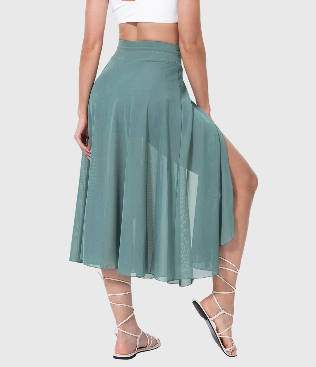A woman in an elegant high-waisted flowing skirt, styled for a versatile day-to-evening look.