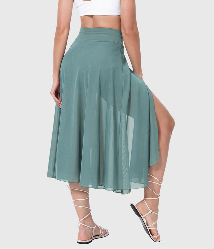 A woman in an elegant high-waisted flowing skirt, styled for a versatile day-to-evening look.