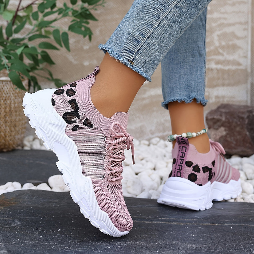A woman walking in light, breathable comfort sneakers on a warm day.