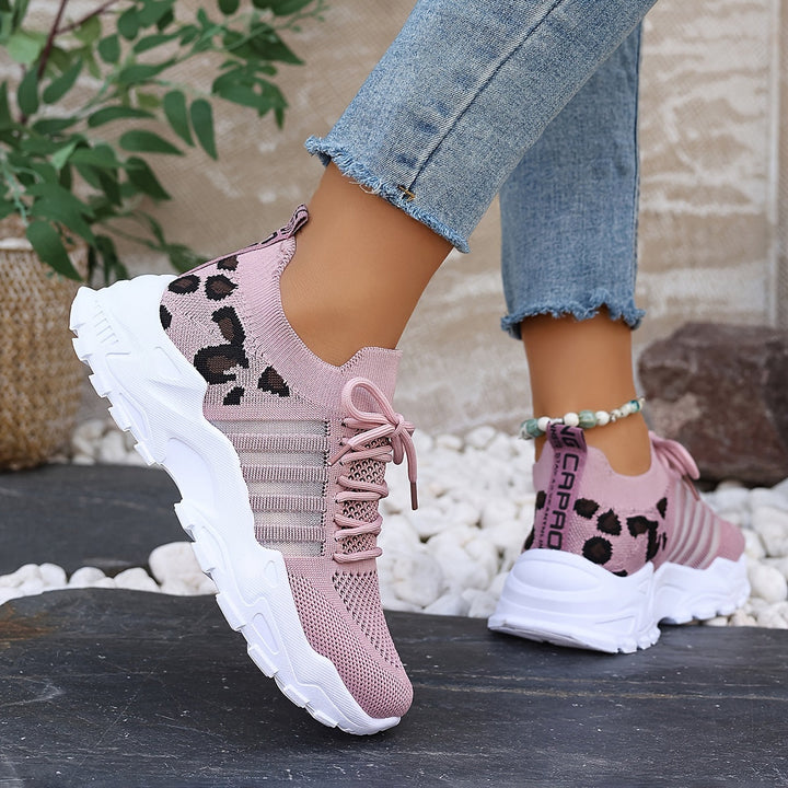 A woman walking in light, breathable comfort sneakers on a warm day.
