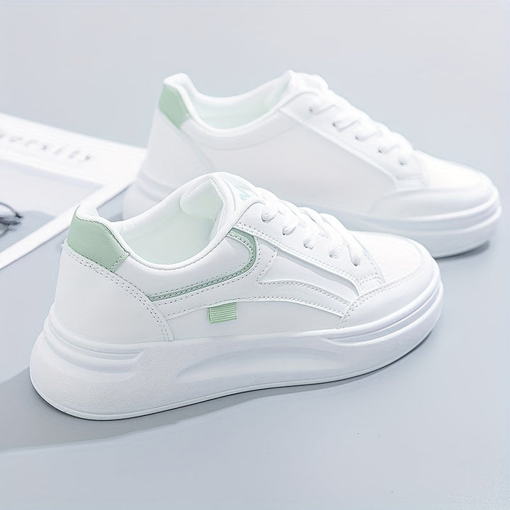 A woman in crisp white light comfort sneakers paired with jeans.