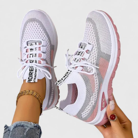 A woman lacing up light, breathable orthopaedic sneakers before a walk.