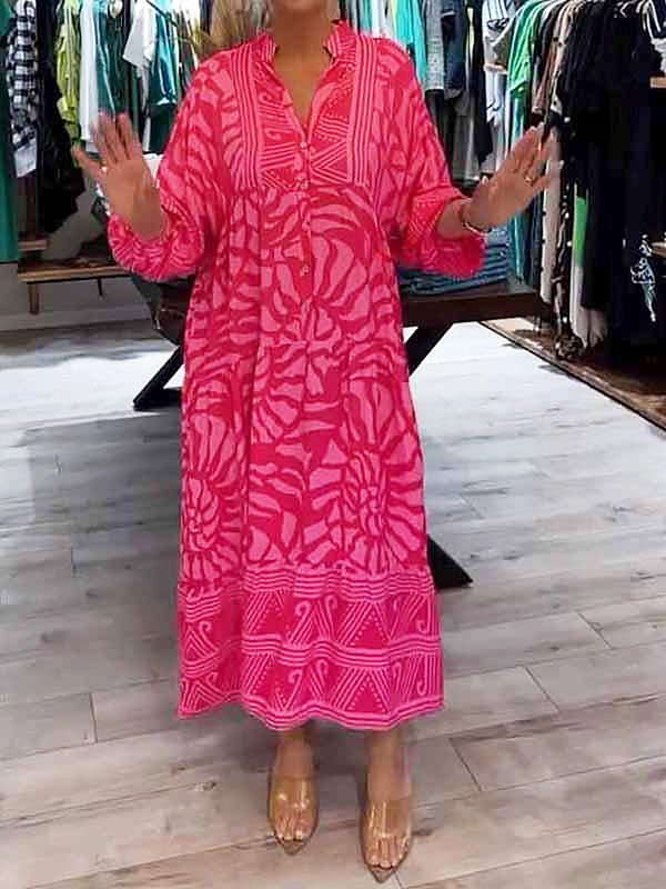 Woman wearing the Gina™ vivid printed maxi dress with a button front, standing confidently outdoors.