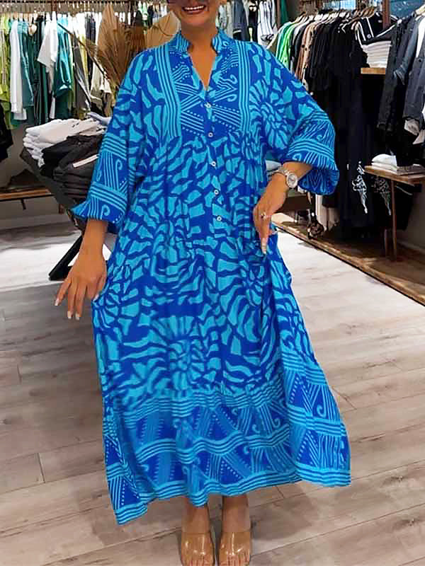 Woman wearing the Gina™ vivid printed maxi dress with a button front, standing confidently outdoors.