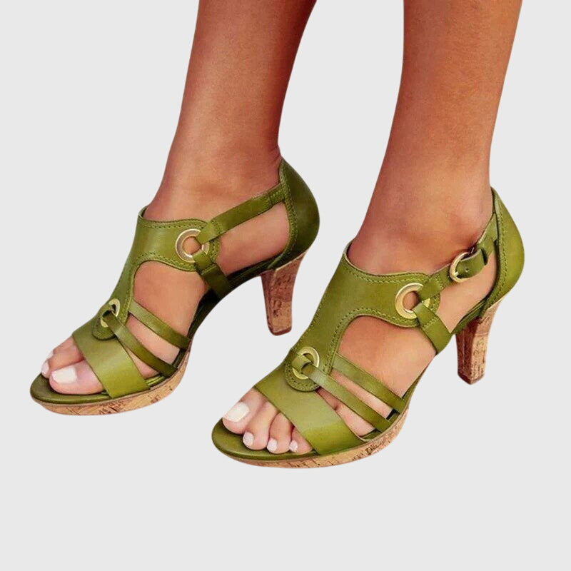 A woman in supportive heeled sandals standing comfortably at a summer event.