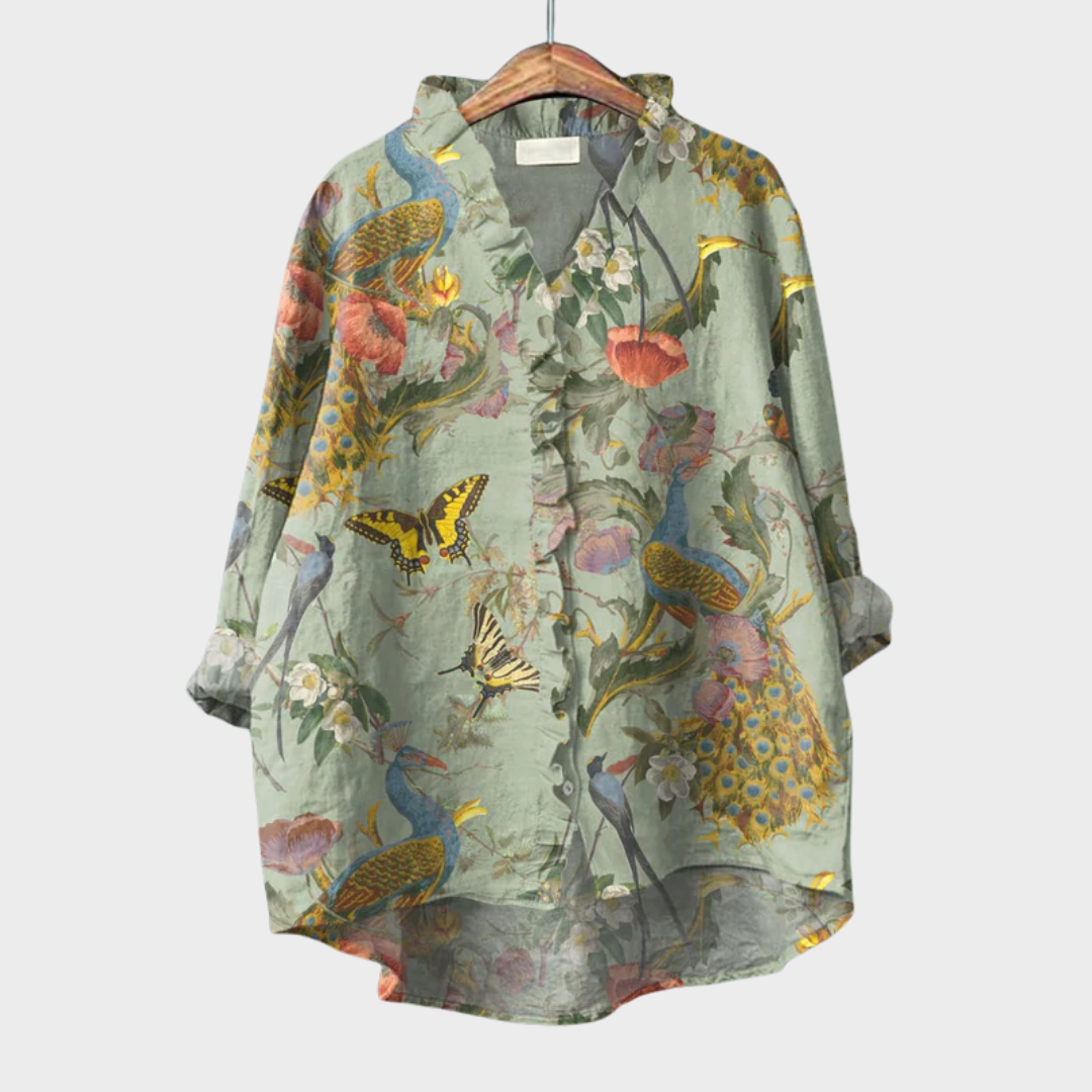 Woman wearing a green printed summer blouse with a soft, elegant fall.