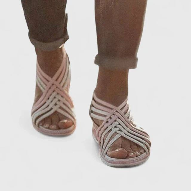 A woman walking with ease in elegant wide-fit everyday sandals with a cushioned footbed.