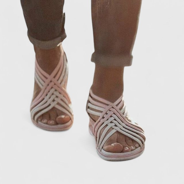 A woman walking comfortably in wide-fit multi-strap orthopaedic sandals with an open design.